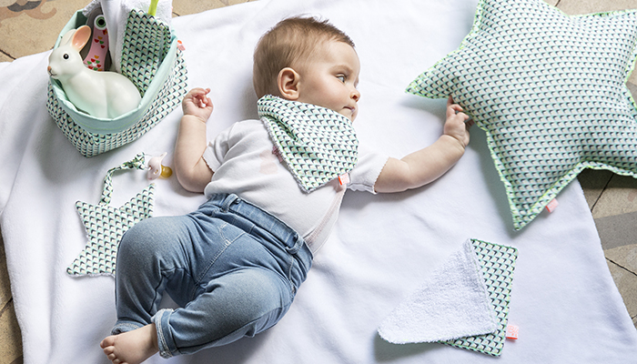 Un bébé allongé autour de produits Blanc Fluo Un bébé allongé autour de produits Blanc Fluo